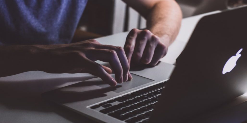 person-touching-open-macbook-on-table-839465